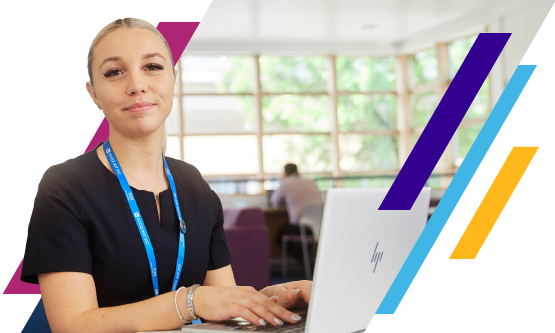 NHS agency management professional sitting next to a laptop and smiling